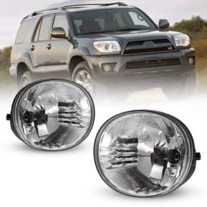 Gray SUV driving on a dirt road with two large round headlights shown in the foreground, likely aftermarket fog lights awaiting installation.